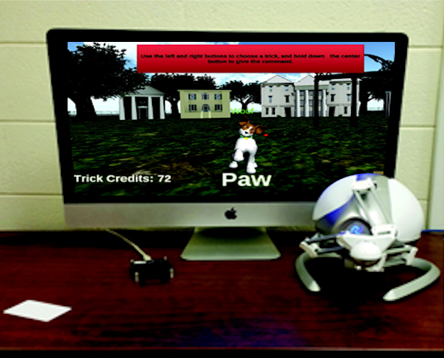 Virtual Buddy Fruit and Vegetable (VB-F&V) Station Virtual dog on a screen with a haptic joystick controller.